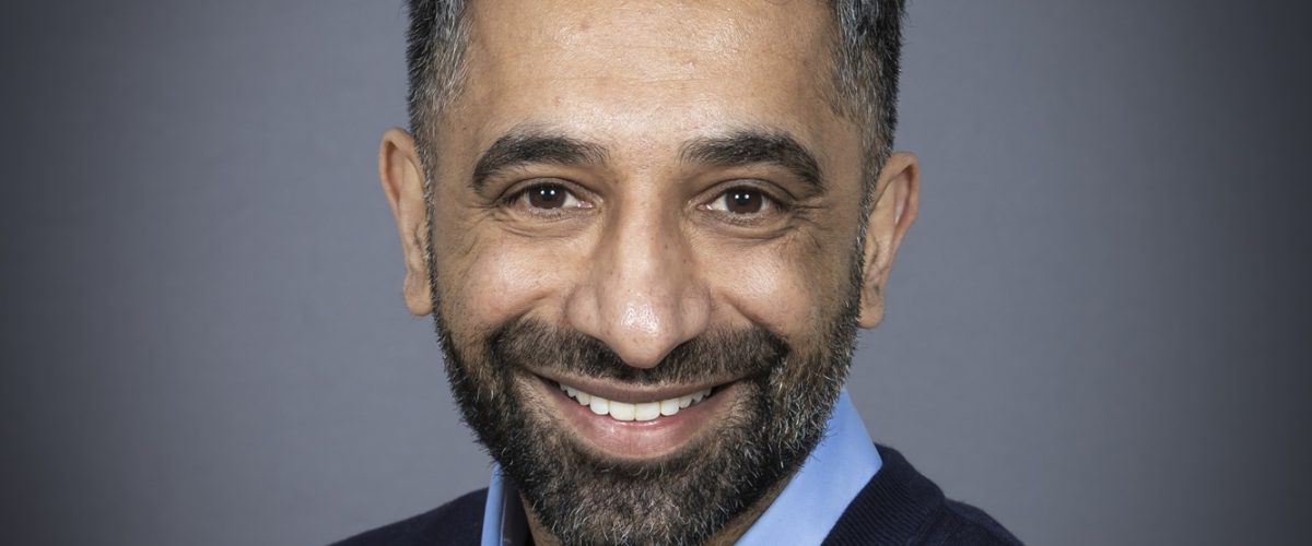 Headshot of trustee Parminder Khaira, smiling at the camera