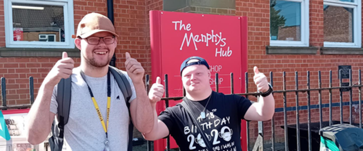 Students Aidan and Bertie in front of the Menphys Hub sign