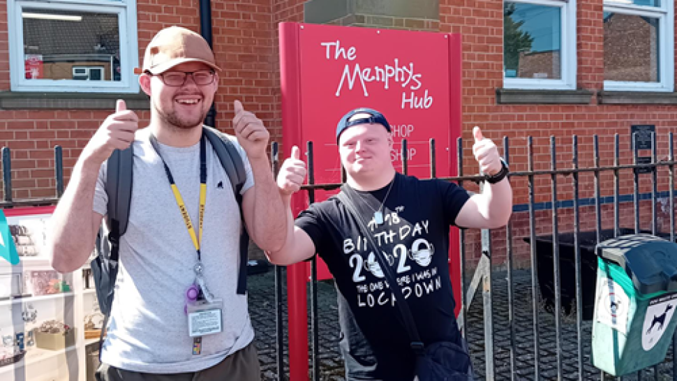 Students Aidan and Bertie in front of the Menphys Hub sign