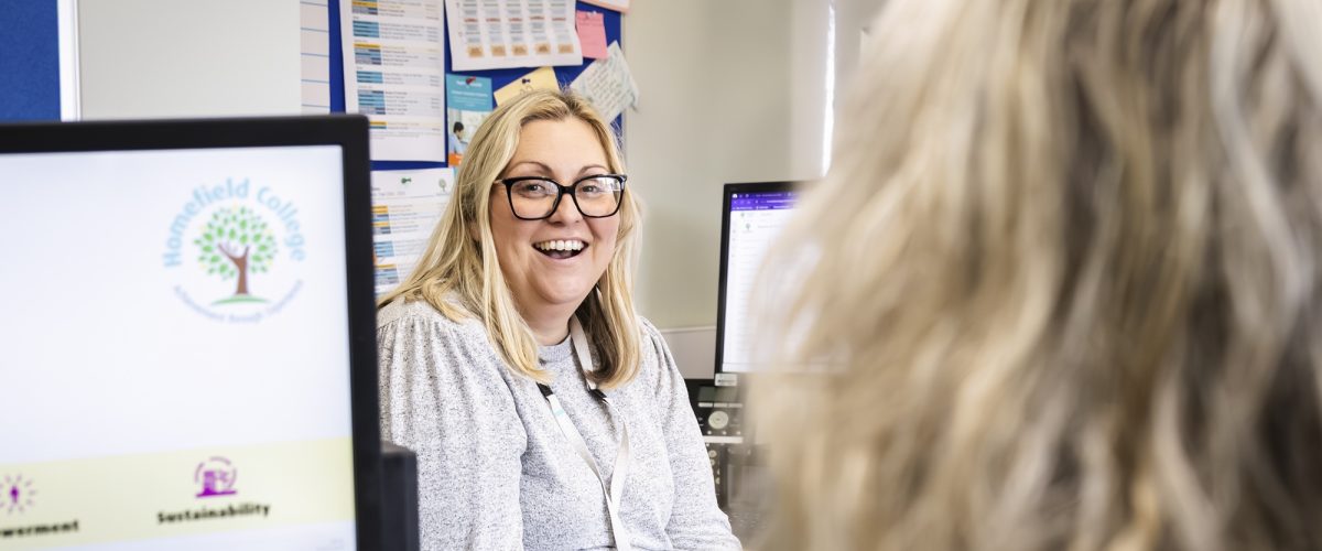 Staff member Vikki talking to a colleague