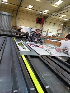 Student Elliott helping assemble a product alongside mentor Kieran