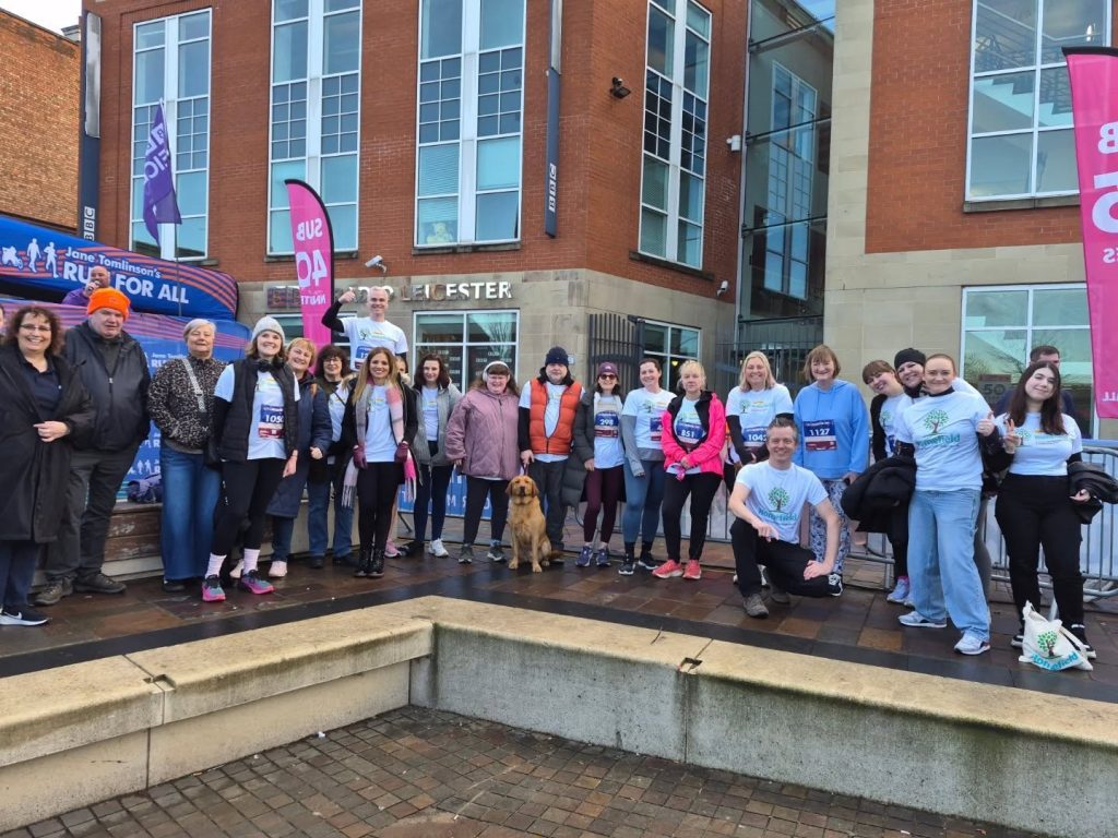 A group photo of Team Homefield all smiling at the camera, most wearing a branded Homefield t-shirt.