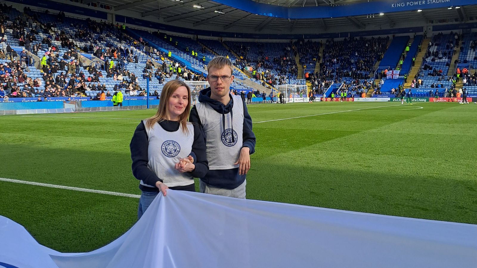 A picture of one of our students smiling at the camera alongside his mum
