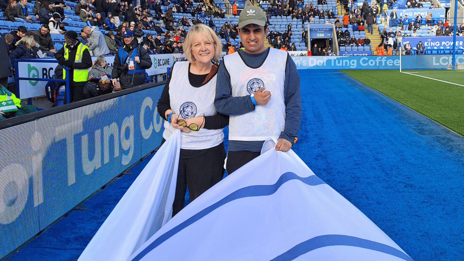 A picture of Principal Tracey and once of our students posing with the flag