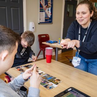 a speech and language therapist signing to a student in a classroom