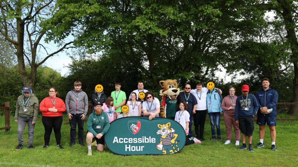A group photo of all attending staff and students wearing their medals and posing with the Welford the Tiger mascot
