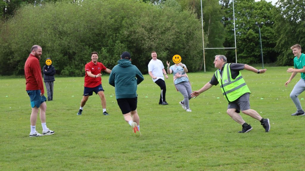 The students and staff playing a short rugby match