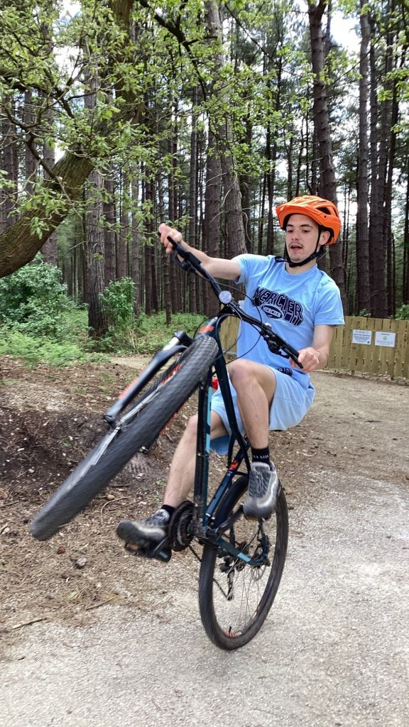 Sean riding his mountain bike in the forest