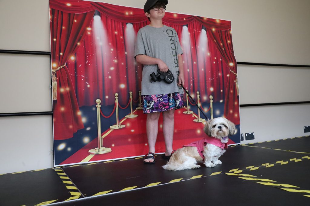 student with their dog, wearing dog coat