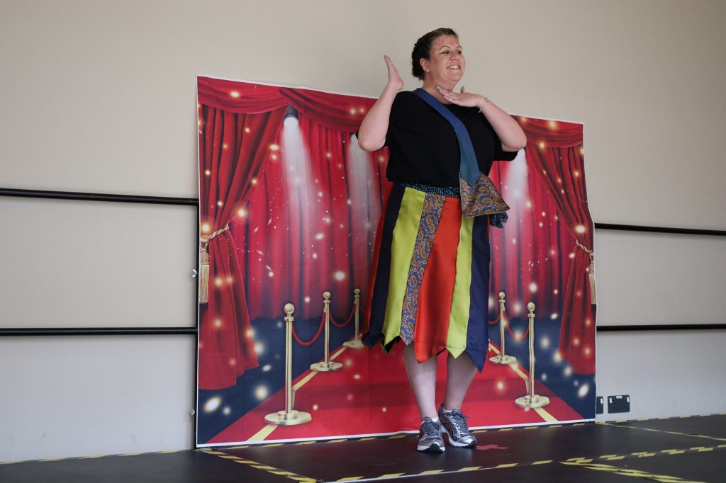 staff wearing skirt made of ties