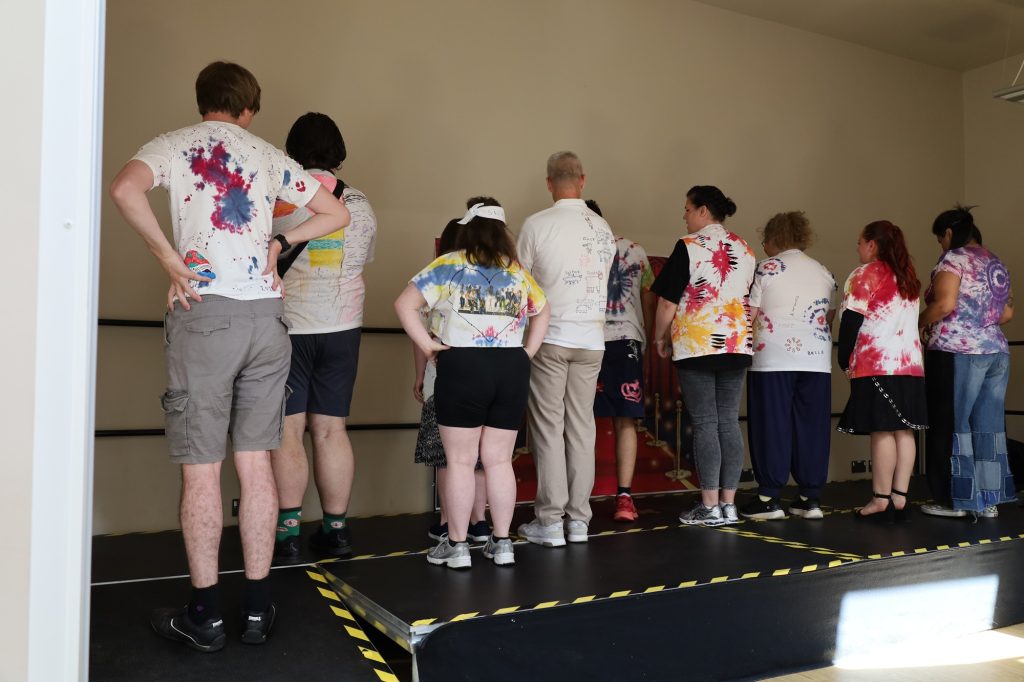 backs of students and staff wearing tie-dye tshirts
