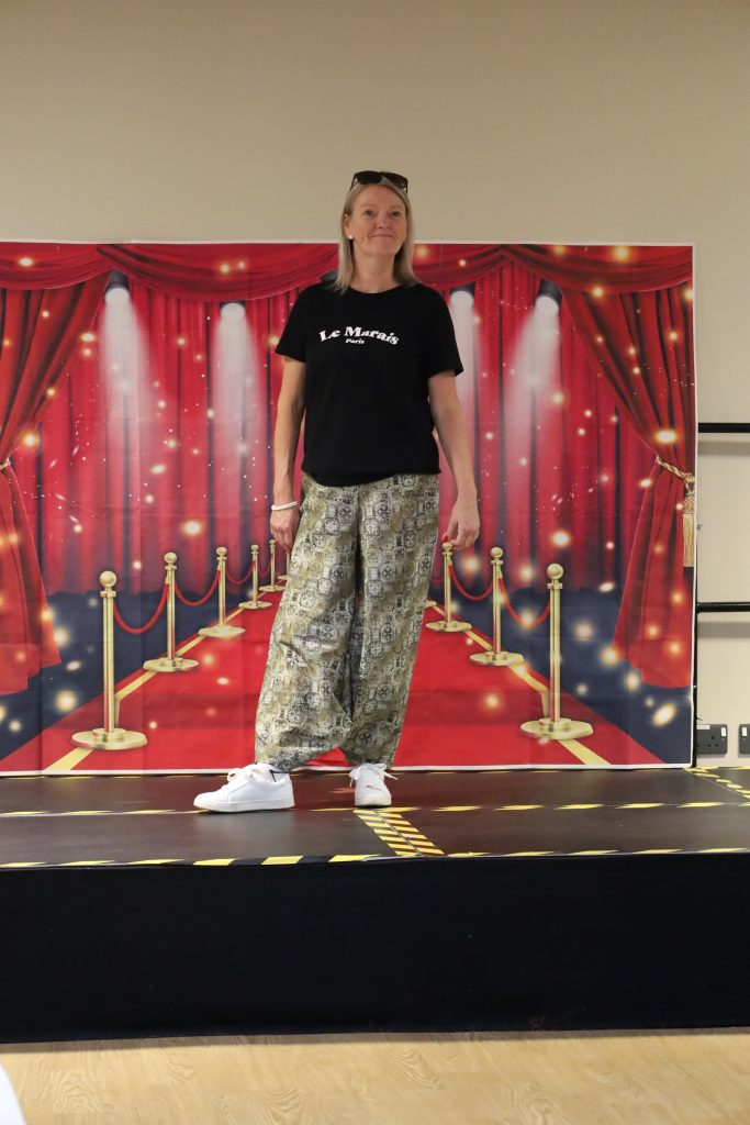 staff on catwalk wearing curtain trousers