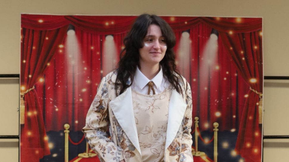 students wearing jacket in front of backdrop