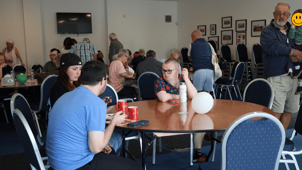 a photo of community learning members and guests attending the event, chatting, or interacting with the stalls
