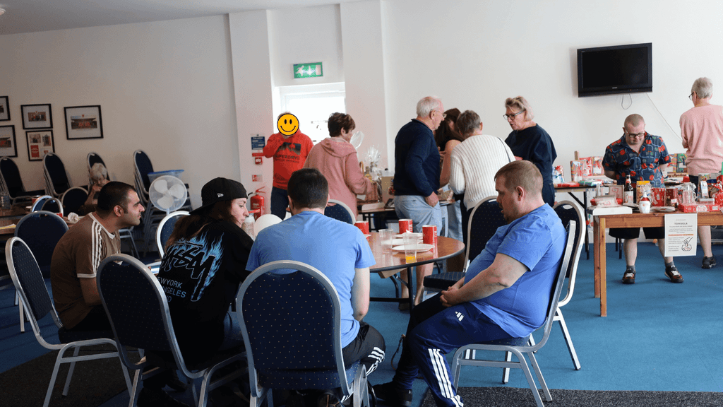 a photo of community learning members and guests attending the event, chatting, or interacting with the stalls