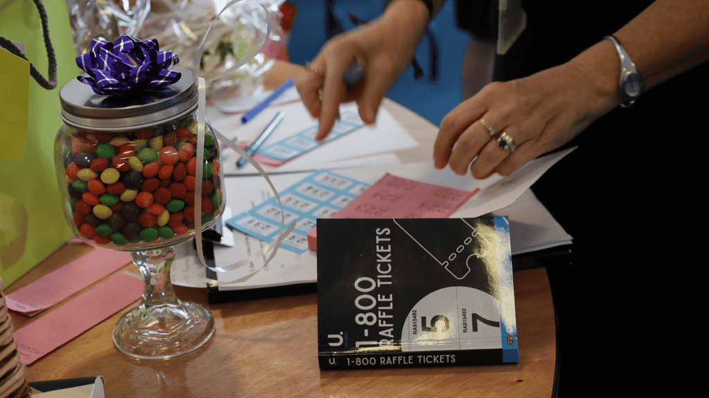 the raffle table, which also features a jar of Skittles
